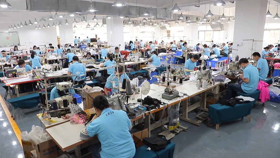 Stacks of custom-designed golf shirts in a variety of colors, ready for shipment, showcasing a scalable and efficient production process.